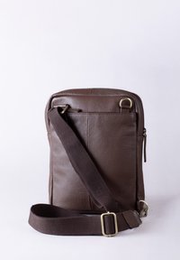 Brown leather crossbody bag with a textured finish, adjustable fabric strap, and zippered pocket on the back. Simple rectangular shape.