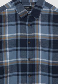 Camicia a scacchi blu e blu navy con dettagli marroni e bianchi, colletto a bottoni e bottoni marroni. Tessuto a trama strutturata. Taglia L.