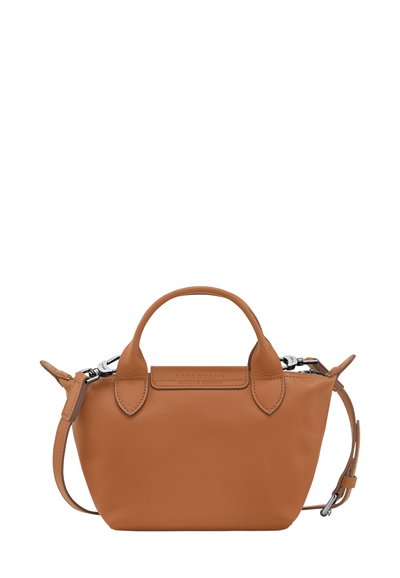 Tan leather handbag with rounded handles, detachable shoulder strap, and silver hardware. Smooth texture with a minimalist design.