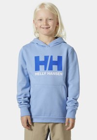 Světle modrá mikina s kapucí vyrobená z měkké tkaniny, s velkým tučným modrým logem "HH" a textem "HELLY HANSEN" na přední straně.