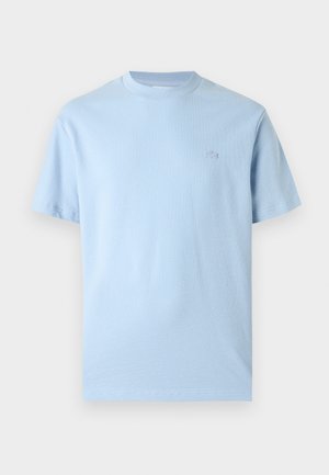 Tricou albastru deschis cu mâneci scurte, din bumbac, cu guler rotund și logo mic brodat pe pieptul stâng, aflat pe un fundal alb.