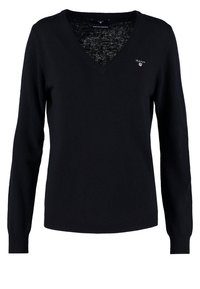 Granatowy sweter w serek wykonany z wyjątkowo cienkiej wełny jagnięcej. Posiada długie rękawy i małe haftowane logo po lewej stronie klatki piersiowej.