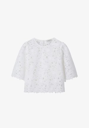 Blouse en dentelle blanche avec motif floral découpé, manches courtes et encolure ronde.