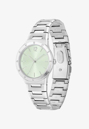 Reloj de acero inoxidable con una esfera verde menta, marcadores de hora plateados y acentos de cristal. Cuenta con una pulsera de eslabones y un cierre seguro.