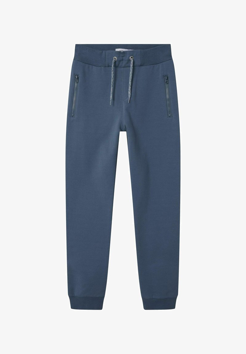 Tumbra zilas sporta bikses ar auklu jostu, ar divām kabatām ar rāvējslēdzējiem un ribotiem aprocēm. Izgatavotas no mīksta, gluda auduma.