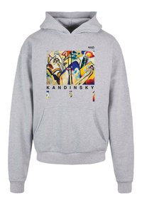 Felpa grigia con tasca frontale e maniche lunghe. Presenta una stampa artistica colorata di Kandinsky sul fronte, con il testo "KANDINSKY" sottostante.