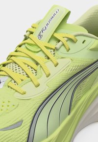 Αθλητικό παπούτσι ανοιχτό πράσινο με κίτρινες κορδόνια, λεπτομέρειες από δίχτυ και μαύρες ρίγες στο πλάι, με ετικέτα "μέγεθος 3" στη γλώσσα.