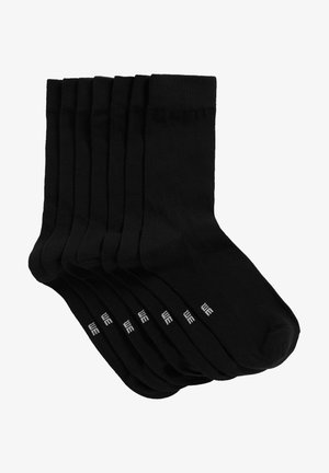 Calzini crew in cotone neri, fascia elastica nella parte superiore, punta senza cuciture, con marchio bianco sul lato, confezionati in un set di sette.