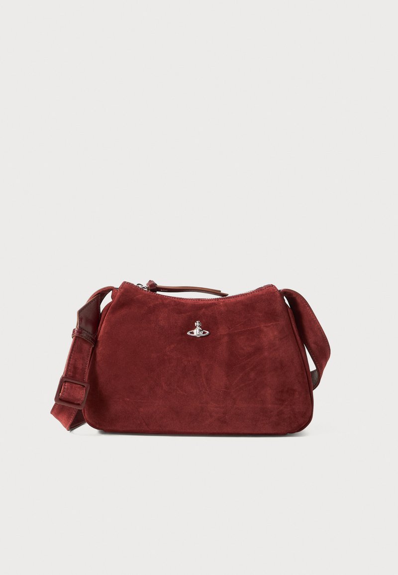 Red suede crossbody bag with adjustable strap, silver orb logo on front, and top zipper closure against white background.