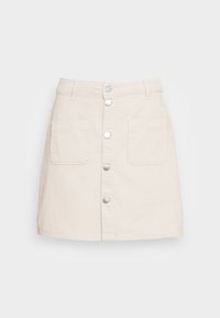 Beige kordflorskjol med knappstängning fram, två framfickor och rak form. Det strukturerade tyget ger ett visuellt intresse.