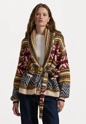 Knitted cardigan in vibrant colors with geometric and floral patterns. Features a wide shawl collar, belted waist, and ribbed cuffs.