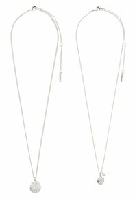 Twee zilveren kettingen met ronde hangers; de ene hanger is textuur met kleine kristallen en de andere is glad met parel- en kristalaccenten.