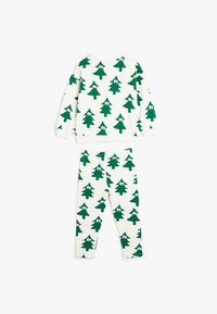 Sæt i bomuld med en hvid base, der har gentagne grønne træmønstre og tegneserieøjne. Indeholder en langærmet top og matchende leggings.