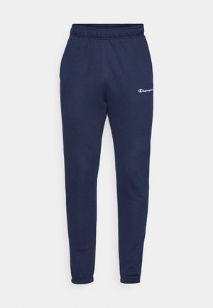 Pantalons de survêtement bleu marine en coton doux, avec une taille élastique et un petit logo Champion sur la cuisse supérieure. Design à jambes fuselées.