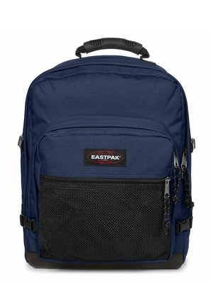 Sac à dos bleu marine avec poche avant en mesh noir, compartiments à double fermeture éclair, sangles de compression latérales et poignée rembourrée sur le dessus.