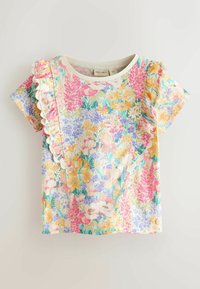 Rövid ujjú, virágmintás kisded felső világos alapon, rózsaszín, sárga és lila virágokkal, fodros szegéllyel az elején és a vállakon.