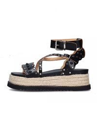 Sandali platform neri in pelle con suola in juta stile espadrille, dettagli con borchie, cinturino alla caviglia regolabile e design a incrocio.