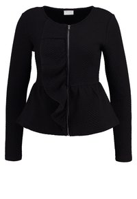 Svart texturerad jacka med långa ärmar, fram zip, och volangdetalj vid midjan.