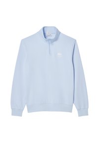 Felpa azzurra chiara con colletto a metà zip, maniche lunghe e polsini e orlo a coste. Presenta un logo bianco di Lacoste sul petto.