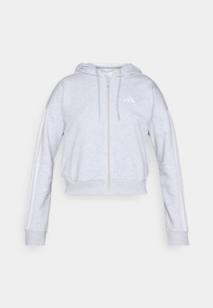 Harmaa lyhythiha hoodie, jossa on vetoketju ja pehmeä kangas. Takaa valkoinen logo rinnassa ja valkoiset raidat hihojen varsilla.
