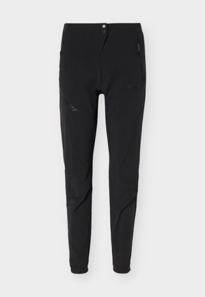 Pantalon noir slim fit avec poches latérales zippées, fermeture par bouton et zip à la taille, et bas élastiqués aux chevilles.