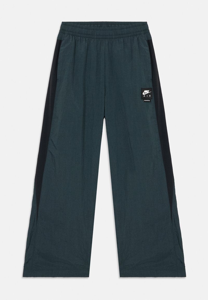 Calças de desporto em azul-teal escuro com painéis laterais pretos, cintura elástica, corte solto e um pequeno logótipo da Nike Air na parte da frente.