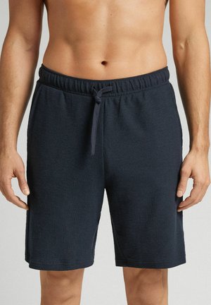 Marineblå bomuldsshorts med elastisk talje og snor, med struktureret stof og knælængde design.