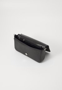 Black faux leather clutch purse with a structured shape, a silver snap closure, and an interior zip pocket for organization.