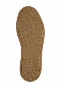 Sole of a brown rubber boot with deep treads and "BLACKSTONE" embossed in the center.