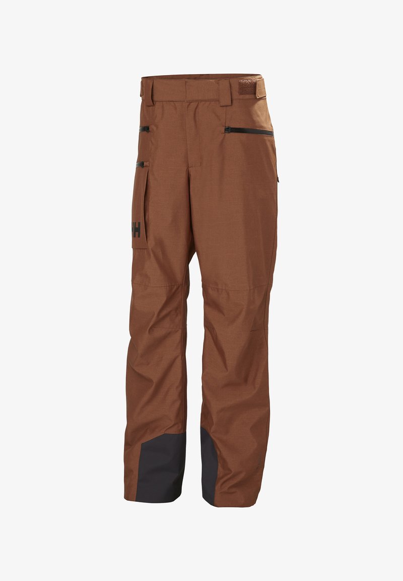 Ski-ondergoed van bruin stof met zwarte accenten, voorzien van twee zijzakken met rits, een riem en versterkte manchetten. Waterafstotend en duurzaam ontwerp.