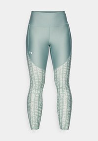 Leggings deportivos en verde claro, con una cinturilla alta y un patrón texturizado en la parte inferior de las piernas. Fabricados con un material elástico que absorbe la humedad.