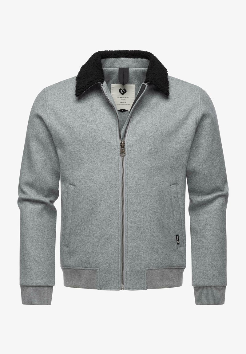 Pilkas vilnonis švarkas su juodu fliso apykakle, priekiniais užtrauktukais ir šoninėmis kišenėmis. Gofruoti rankogaliai ir apatinė dalis suteikia prigludusį įvaizdį.