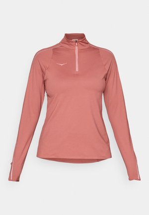 Long-sleeved, zip-up top in light pink fabric. Features a high collar, reflective accents, and a slim fit with textured side seams.
