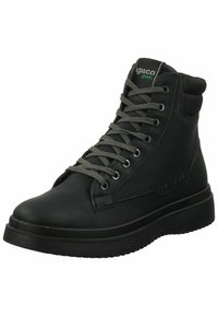 Botas de cuero negras hasta el tobillo con cordones grises, puntera redonda, cuello acolchado y suela de goma texturizada. Logotipo visible cerca del tobillo.