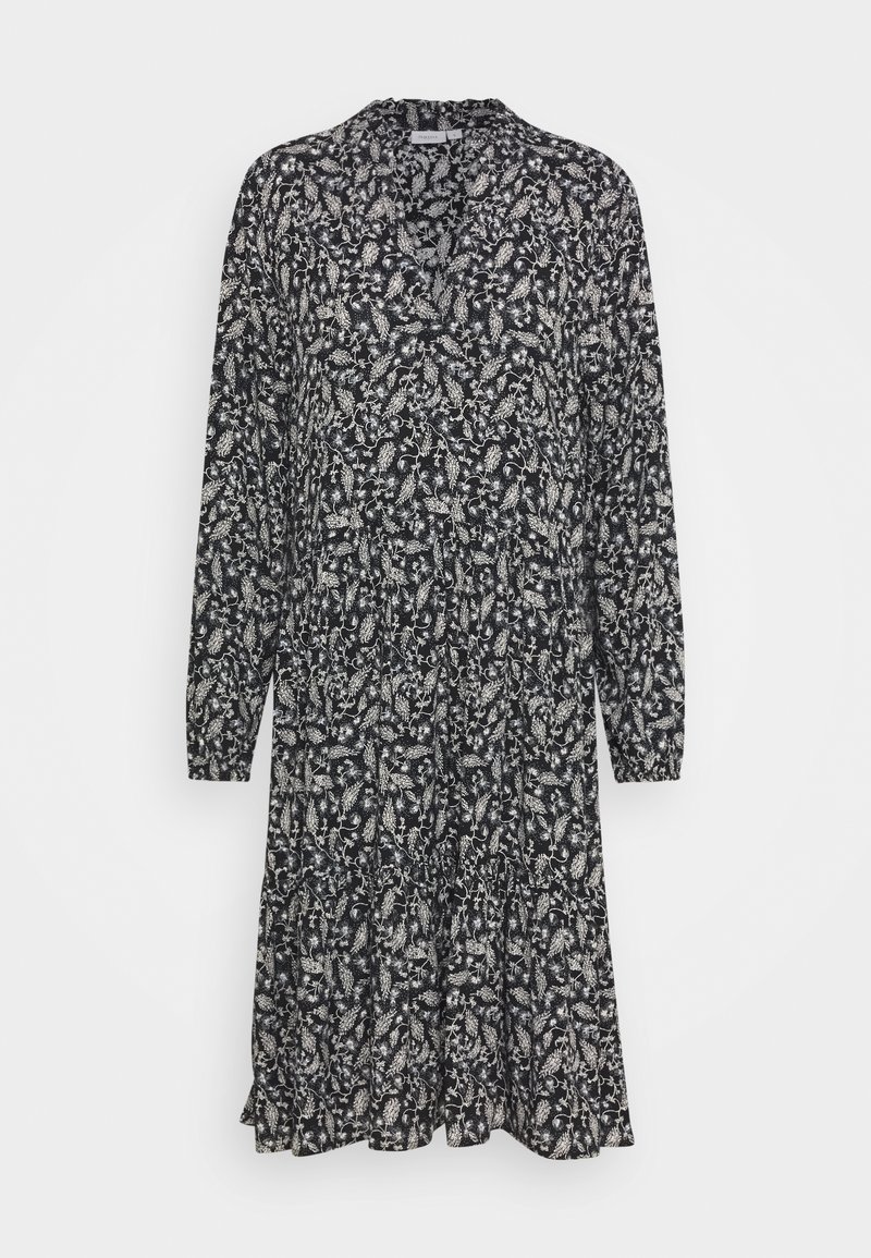 Robe noire à manches longues, avec un motif floral blanc, un décolleté en V et une jupe évasée avec un ourlet à volants. Tissu léger.