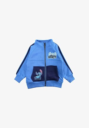 Veste à fermeture éclair bleue pour enfants avec poches bleu marine, rayures bleu marine sur les manches et images du personnage Stitch sur la poitrine et la poche.