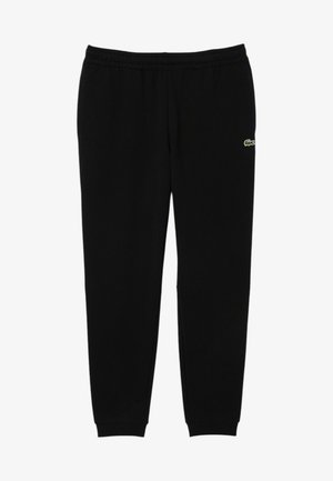 Pantalones de chándal negros hechos de un material suave, con una cintura elástica, puños en los tobillos y un pequeño logo verde en la cadera izquierda.