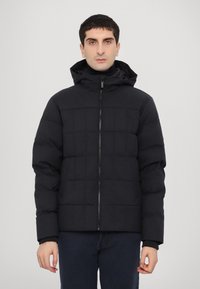 Black puffer jacket with a hood, featuring a quilted design and front zipper. Ribbed cuffs and a subtle sheen in fabric texture.