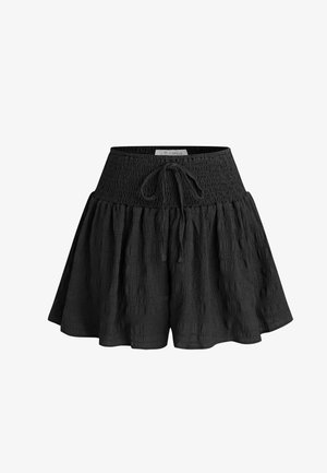 Shorts noirs dotés d'une taille texturée smockée avec une fermeture à nouer et un design évasé. Fabriqués en tissu léger.