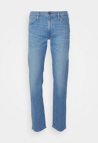 Ljusblå slim-fit jeans med fem fickor, knappstängning, bälteshällor och subtila blekningar på framsidan av låren, mot en vit bakgrund.