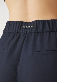 BLANCHE LION PANTS - Nadrágok - rinse