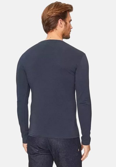 Camicia a maniche lunghe da uomo in blu navy scuro, realizzata in cotone morbido. Presenta un collo rotondo e una silhouette aderente, senza motivi o grafiche visibili.