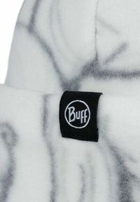White fleece beanie with marble-like gray patterns, featuring a black "Buff" logo label sewn on the side. Soft texture and slouchy shape.