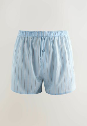 Light blue cotton boxers with thin vertical stripes, an elastic waistband, and a front button detail. Smooth texture and relaxed fit.