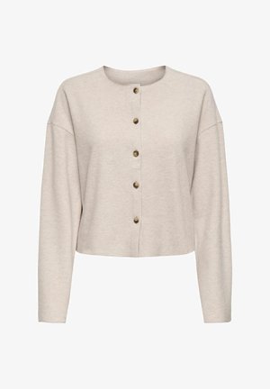 Gai bēšas krāsas saīsināts kardigāns, izgatavots no mīksta auduma, ar apaļu dekoltē un pieciem zelta tonī pogām priekšā, ar garām piedurknēm.