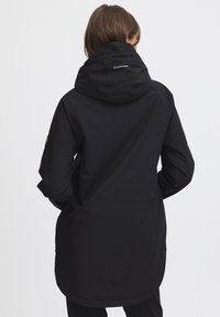 Black waterproof jacket with a hood, featuring a regular fit, smooth texture, and a logo on the back, suitable for outdoor wear.