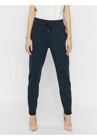 Marinblå tapered byxor med dragsko i midjan, sidofickor och en mjuk tygkvalitet. Lämpliga för avslappnad eller ledig klädsel.