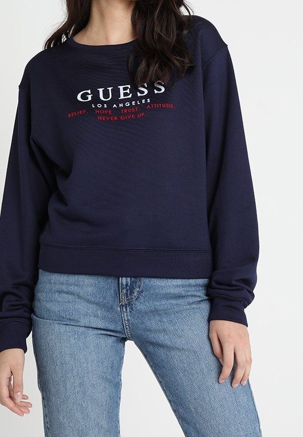 Námořnická modrá mikina ze směsi bavlny s bílým a červeným logem "GUESS LOS ANGELES". Žebrované rukávy a lem v uvolněném střihu.