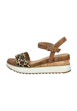 Brown suede sandal with leopard print strap, adjustable ankle buckle, and textured cork-wrapped wedge sole, featuring a white platform base.