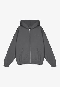 Grå zip-up hoodie gjord av mjukt material med huva, oversized passform, framfickor och subtil "PEGADOR"-logotyp tryckt på bröstet.